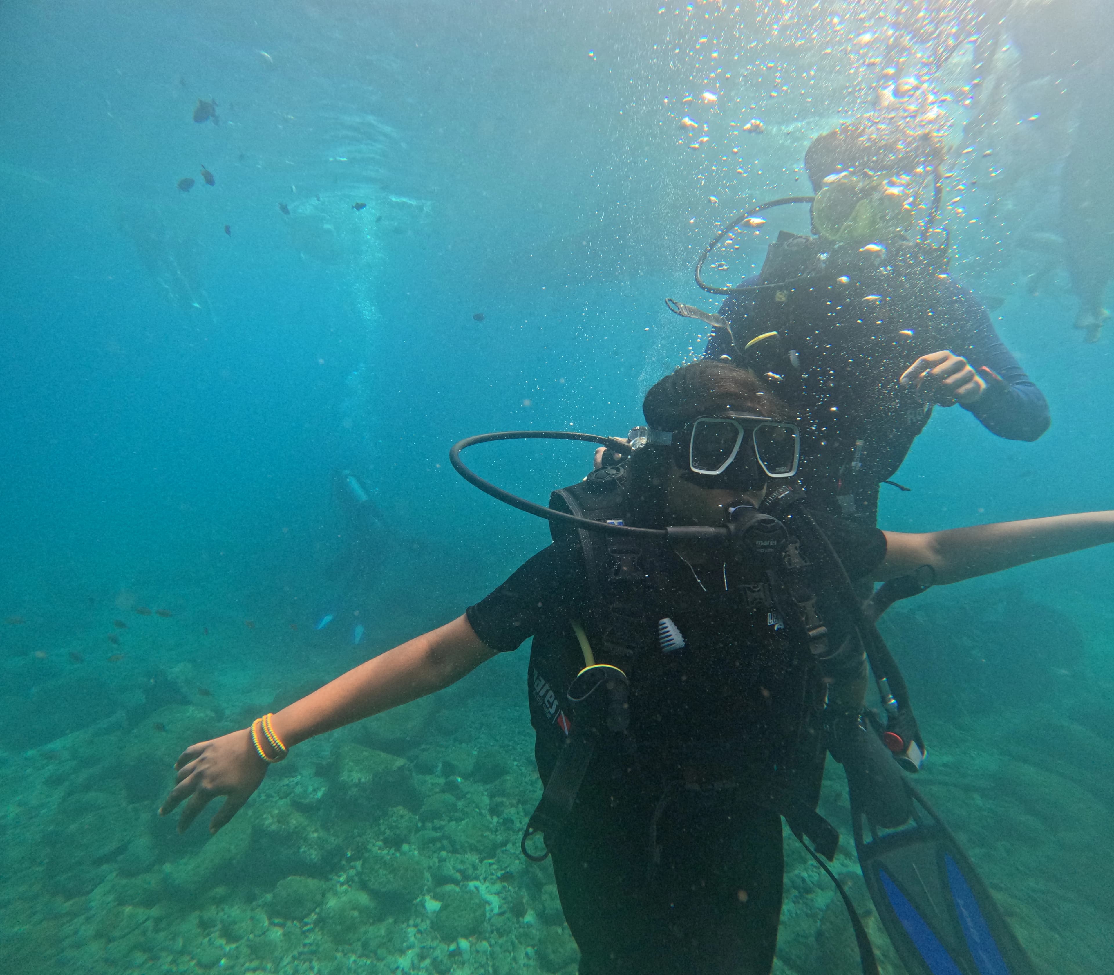 First-time scuba diver experiencing Netrani Island coral reef with certified dive guide